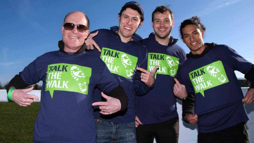men in talk the walk t-shirts smiling