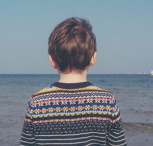 A child looking out to sea