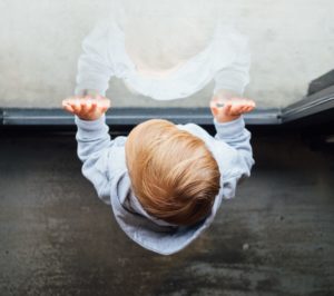 A young child looking out of a window