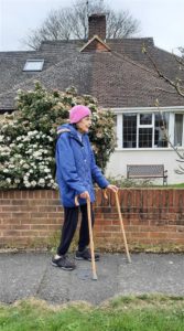Jan walking using her walking sticks to help raise money for the Hospice