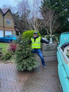 Man with a Christmas tree