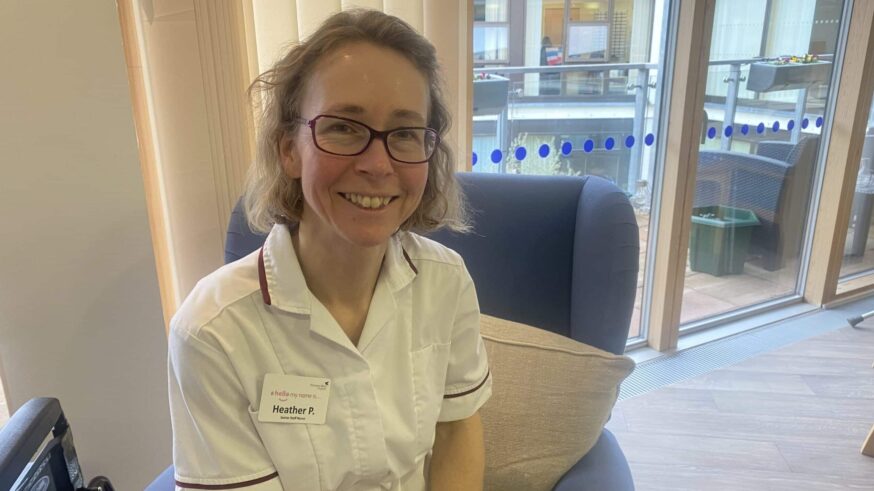 Nurse in uniform smiling at the camera