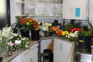 lots of flowers in buckets in our flower room