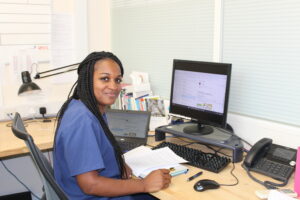 Ria at her desk, smiling