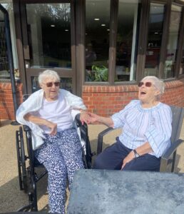 Two ladies laughing in the garden