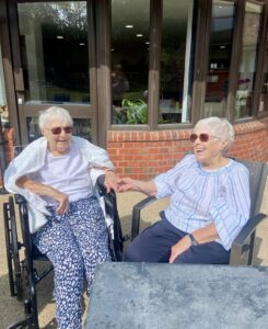 Two ladies laughing in the garden