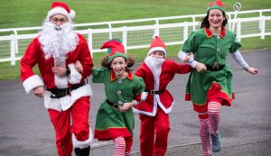 Smiling family dressed as Santa