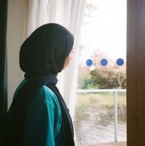 Farida looking out of the window