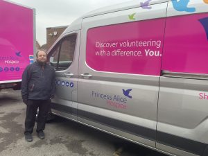 Man standing in front of pink branded van