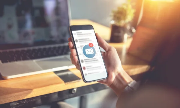 someone holding a phone with an email received
