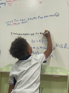 Young child drawing on the wall in the children's room