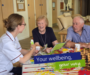 Wellbeing nurse and two people chatting