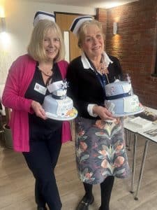 Sandi and Donna holding cake