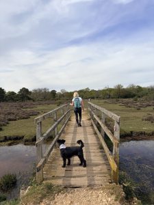 Heather and her dog on a bridge