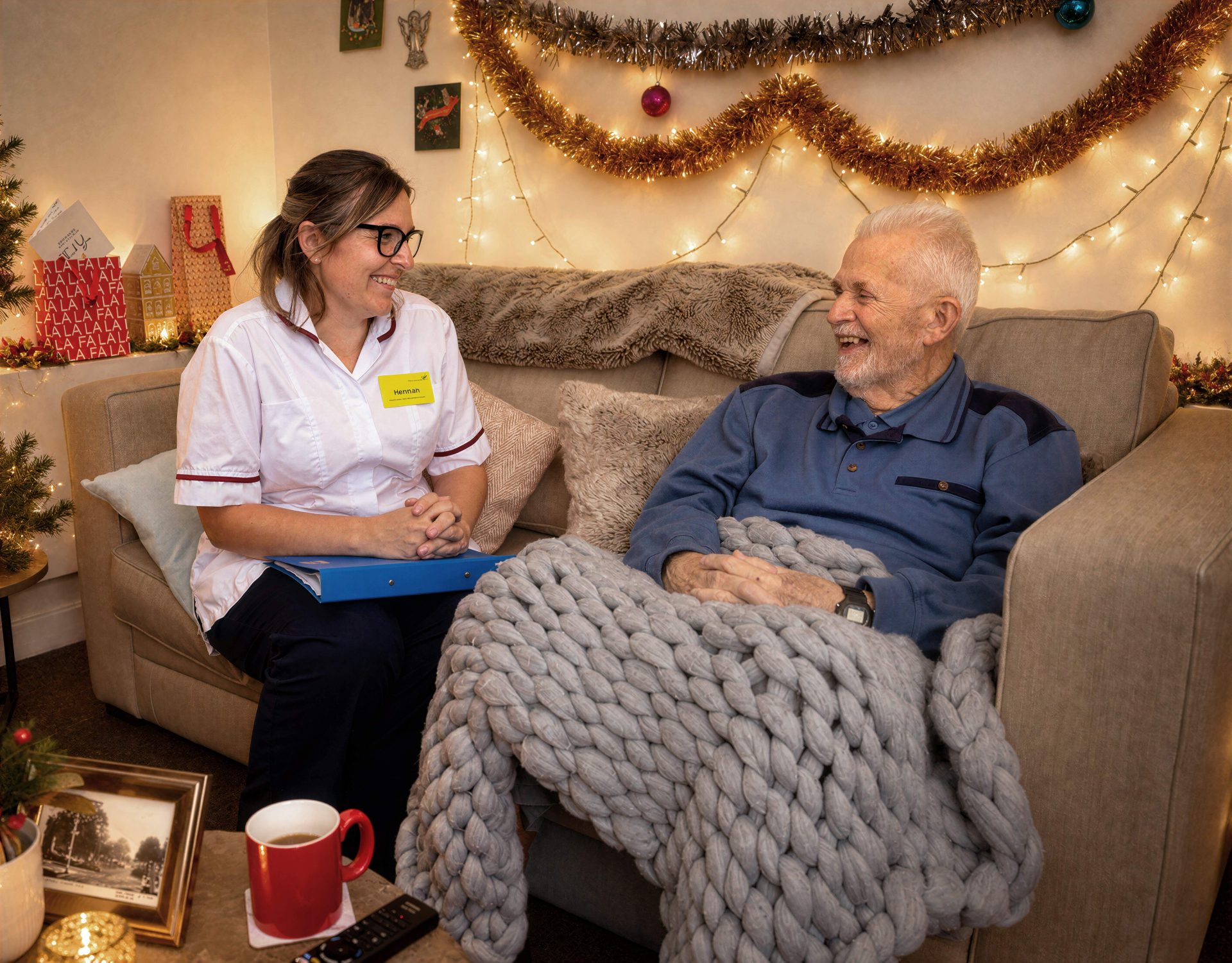 patient and nurse in home environment with christmas decorations